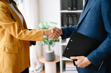Obraz premium Two confident business man shaking hands during a meeting in the office, success, dealing, greeting and partner