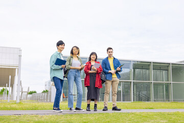 Group of multinational young people smiling in college campus.