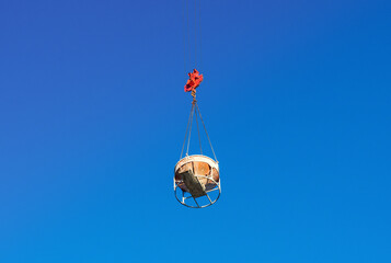 Obraz premium Tub on tower crane for concrete blue sky on background