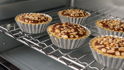 Baking tray with mini brownie pies in the oven, ready to be served.