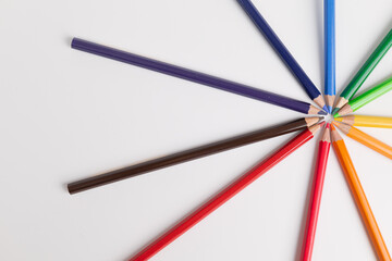 Fototapeta premium Circle of colored pencils on a white background. colorful and brightness concept. Pride Month. gender diversity. cultural diversity. free space for advertising. backdrop for advertising.