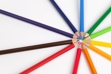 Fototapeta premium Circle of colored pencils on a white background. colorful and brightness concept. Pride Month. gender diversity. cultural diversity. free space for advertising. backdrop for advertising.
