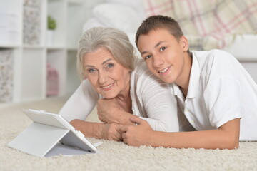 girl with grandmother using tablet