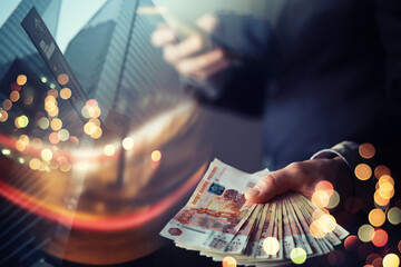 Businessman in suit holding money in his hands. Freedom, success man double exposure skyscraper