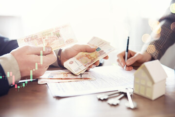 Businessman counting money, Russian ruble currency, while making an agreement contact with his...