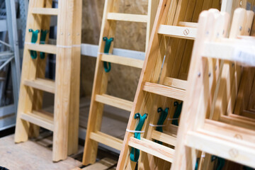 Many Wooden ladders. Stack of wooden stairs in a store.