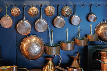 Copper Pots and Pans and other Kitchen Utensils in an Antique Metal Kitchen