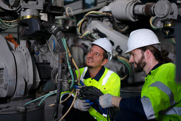Engineer work at robotic arm factory.