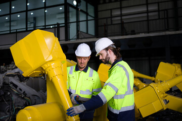 Engineer work at robotic arm factory.