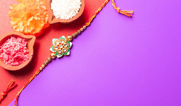 Raksha Bandhan, Indian festival with beautiful Rakhi and Rice Grains.  A traditional Indian wrist band which is a symbol of love between Sisters and Brothers.