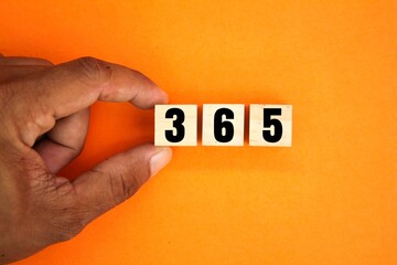 wooden cube with words or numbers of 365 days. the concept of counting the days of the year