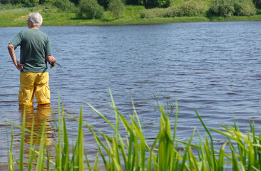 Fototapeta na wymiar Senoir man fishing in a river