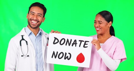 Happy doctors, team and billboard on green screen for donate blood against a studio background. Portrait of man and woman in medical or healthcare teamwork and sign or poster for advertising donation