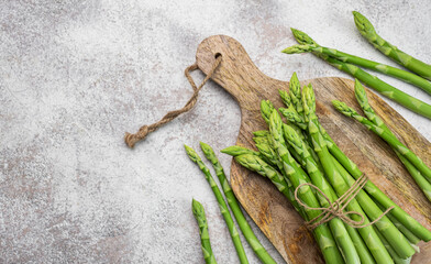 Fresh green asparagus on  concrete background.