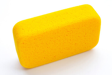 Yellow sponge on white background.  Copy space
