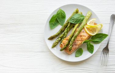 Baked Delicious salmon, green asparagus on  plate