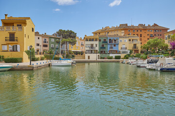 Obraz premium Panoramic view of colorfull houses and moored yachts in Port Saplaya