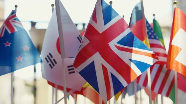 World flags fluttering in wind close-up. Closeup national symbols of countries outdoors