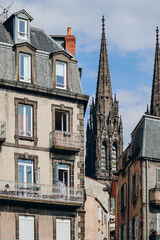 Fragment of the facade of an old building in the center of Clermont Ferrand, France
