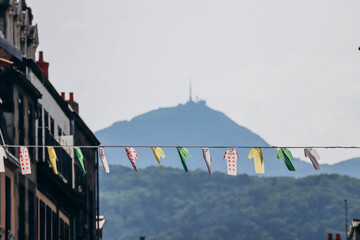 Decoration imitating drying clothes strung across a street in Clermont Ferrand, with the Puy de Dome volcano in the background