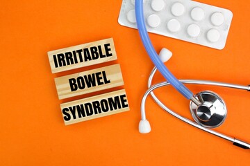 stethoscope and medicine with the word Irritable Bowel Syndrome or IBS. medical concept