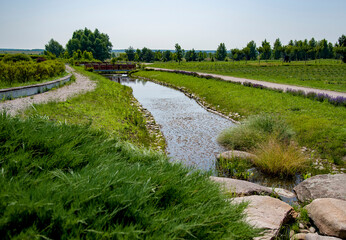 river and path in the park on sunny summer day