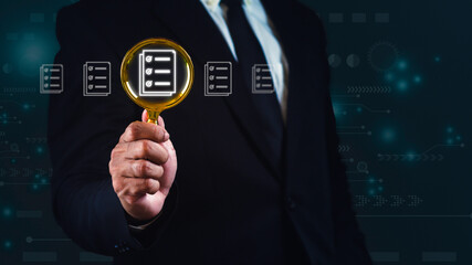 Businessman using magnifying glass for looking quality documents against graphic blue background.