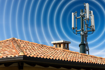 Closeup of a house roof with a telecommunications tower with antennas (aerial) and radio waves,...
