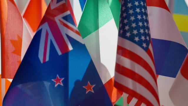 Close-up United Kingdom and United States flags at background of other countries national flags. Concept of political cooperation and international unity