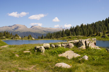 MOUNTAIN LANDSCAPE WITH LAKE. MOUNTAINS IN THE BACKGROUND