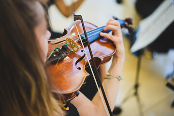 Unrecognizable woman playing the violin in public