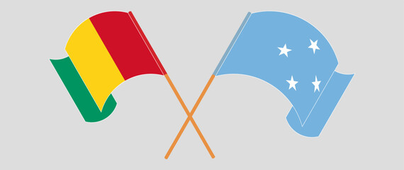Crossed and waving flags of Guinea and Micronesia