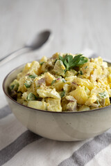 Homemade Potato Egg Salad with Pickles in a Bowl, side view.