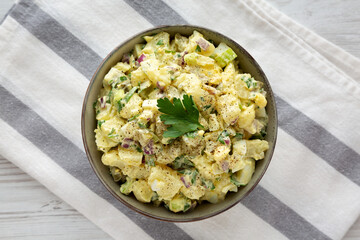 Homemade Potato Egg Salad with Pickles in a Bowl, top view. Flat lay, overhead, from above.