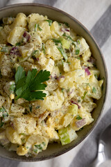 Homemade Potato Egg Salad with Pickles in a Bowl, top view. Flat lay, overhead, from above. Close-up.