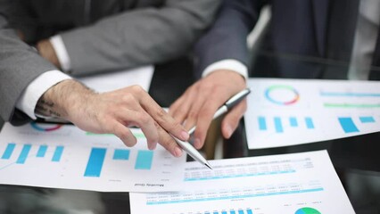 Businessman working at office desk, he is building a growing financial graph using wooden toy blocks.