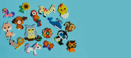 figurines made of beads. cute children's crafts. handmade work. small toys. design background