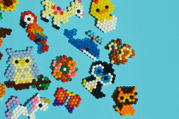 Obraz premium figurines made of beads. cute children's crafts. handmade work. small toys. design background