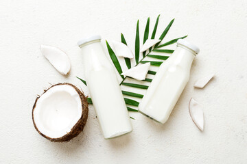 coconut products on white wooden table background. Dairy free milk substitute drink, Flat lay healthy eating