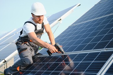 Worker installing solar panels outdoors.