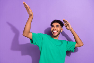 Photo of dance youngster guy listen music party discotheque hands up looking corner chill motion isolated on purple color background