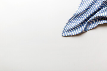 top view with blue kitchen napkin isolated on table background. Folded cloth for mockup with copy space, Flat lay. Minimal style