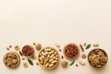 Walnut kernel halves, in a wooden bowl. Close-up, from above on colored background. Healthy eating Walnut concept. Super foods with copy space