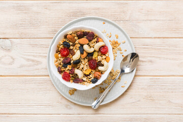 Cooking a wholesome breakfast. Granola with Various dried fruits and nuts in a bowl. The concept of a healthy dessert. Flat lay, top view with copy space