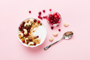 Fototapeta na wymiar Healthy breakfast food with granola, yogurt, fruits and nuts. Dessert parfait with dried fruits for breakfast