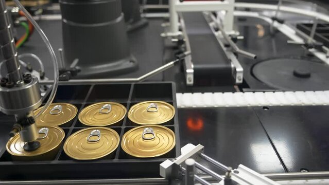material handling process by robotic system with tin can container. The automatic pneumatic robotic arm picking the container box in production line.