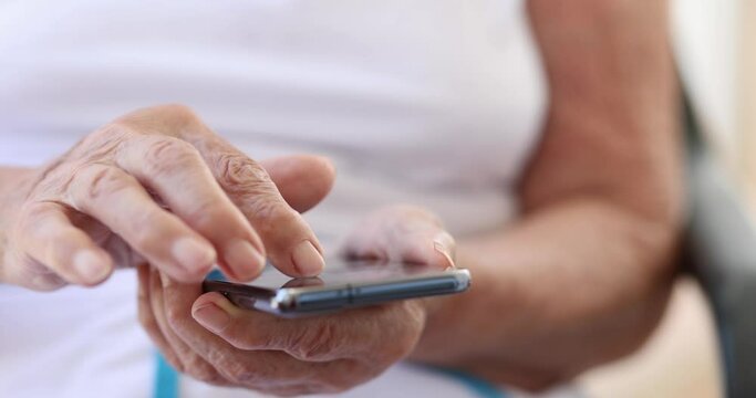 Elderly woman uses smartphone and mobile applications for pensioners. Family chatting concept