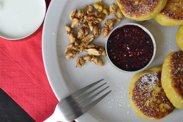 there is jam next to cheese pancakes