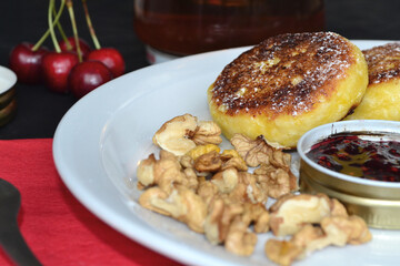 there are walnuts in a plate with cheese pancakes