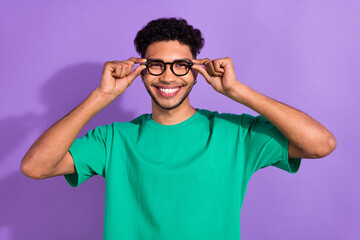 Portrait of cheerful satisfied person toothy smile hands touch glasses isolated on purple color background